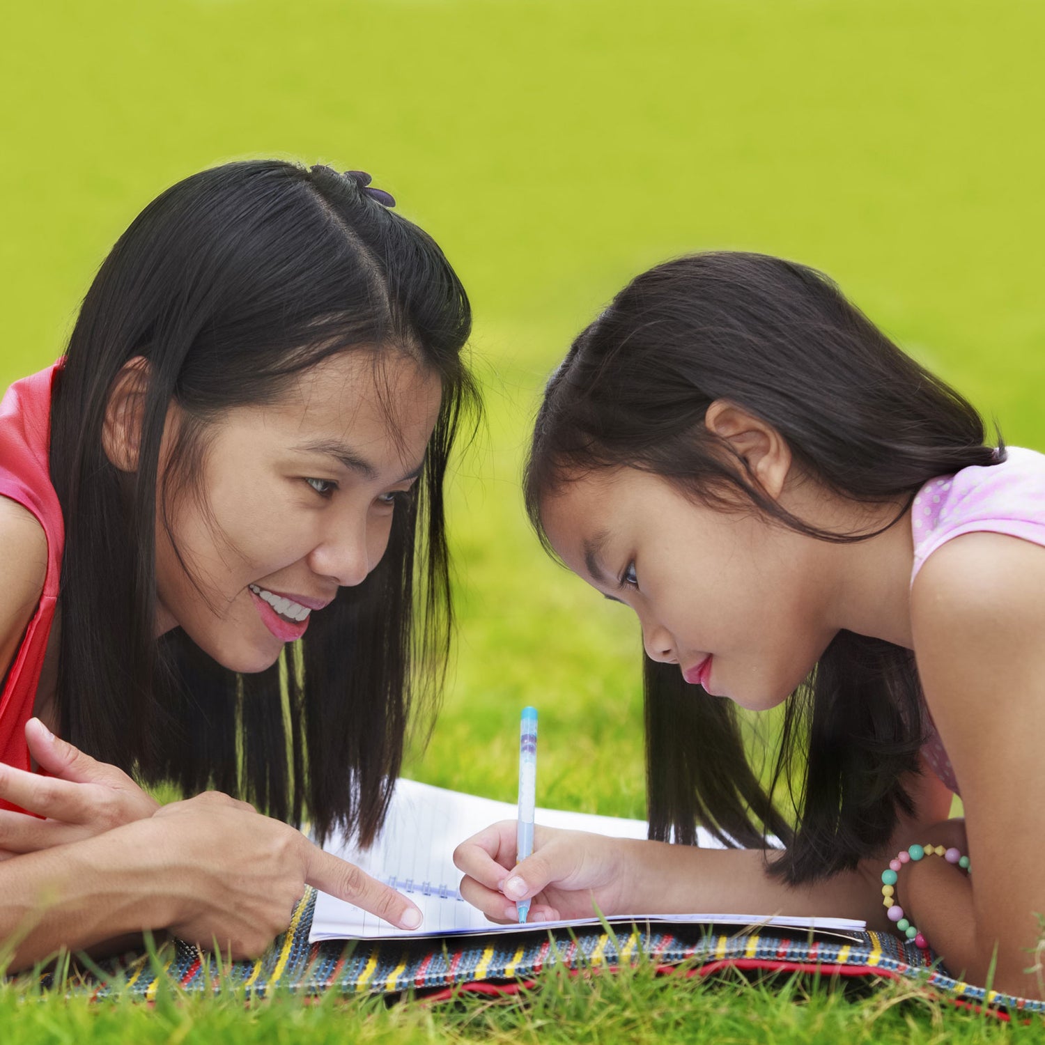 Mother and daughter doing playful math activity outdoors
